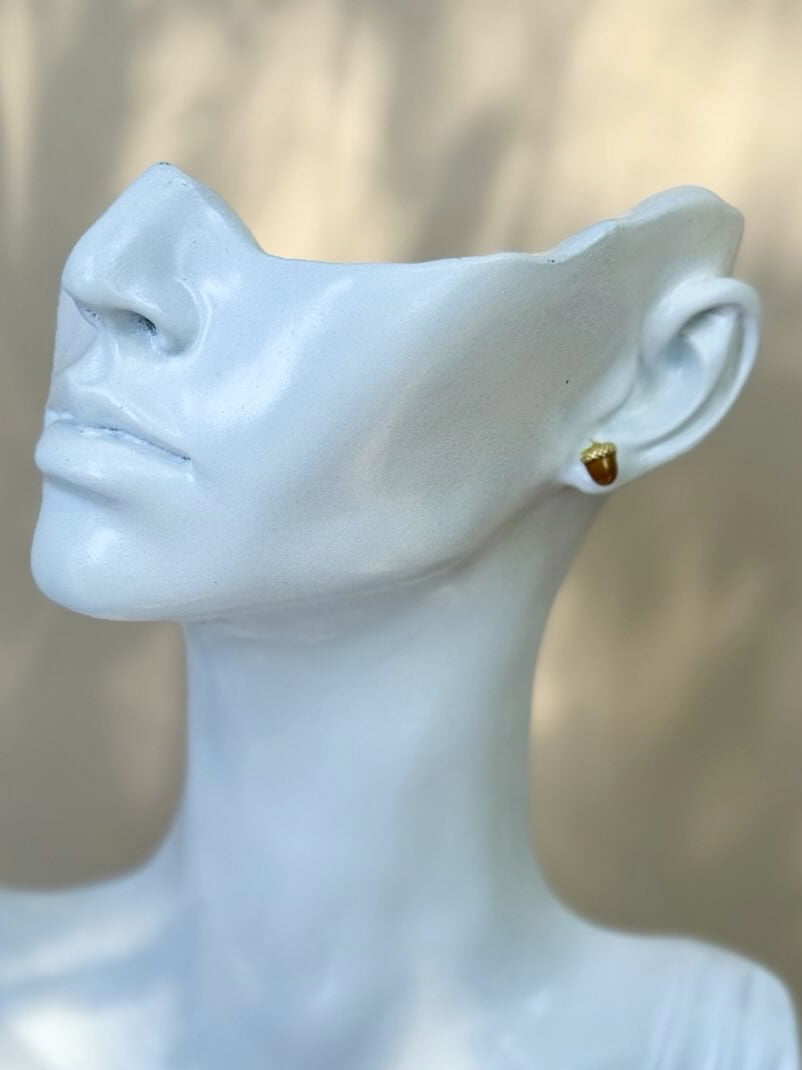 Mannequin bust with a gold earring on a blurred background