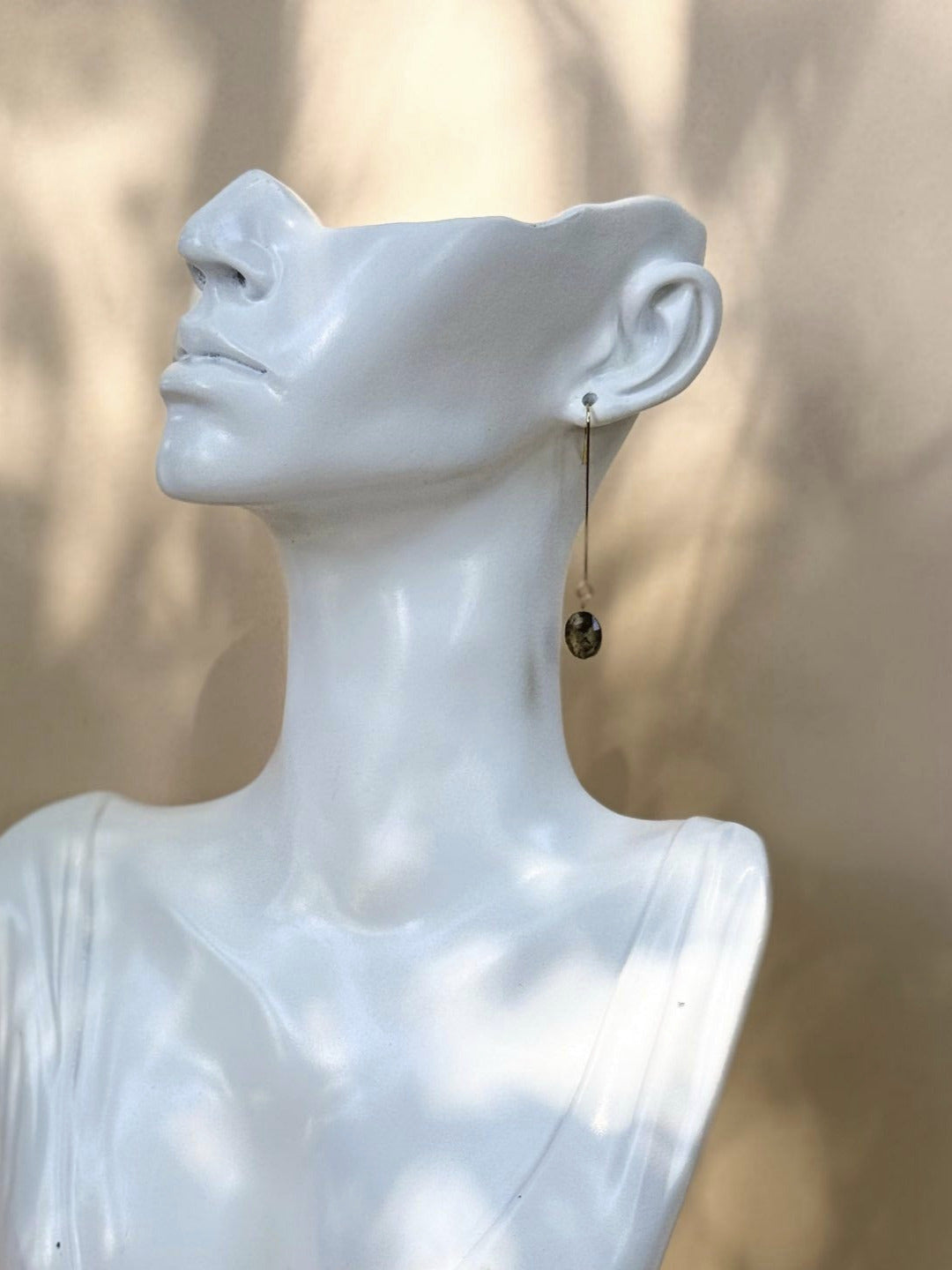 White marble bust sculpture against a neutral background