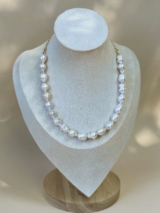 Pearl necklace on a white bust with a blurred background