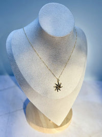 Necklace with a star pendant on a mannequin bust against a blue background